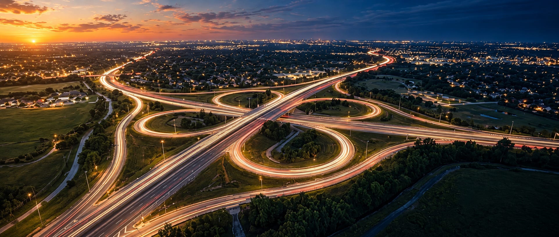 Aerial view of DFW roads transitioning from daylight to night, showing continuous roadside availability